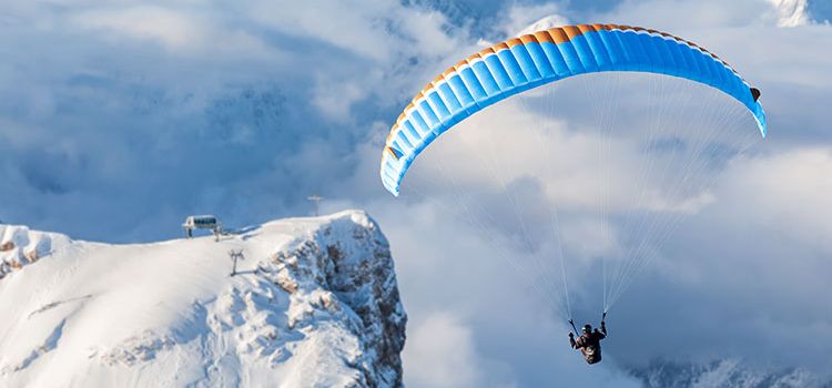 Gleitschirmpilot in den Alpen im Aufwind